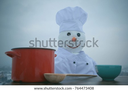 Xmas or christmas cooking. New year snowman in cook hat. Christmas food cooking. Happy holiday celebration. Snowman chef in winter with kitchen spoon and pot.