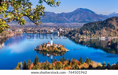 Bled, Slovenia - Panoramic aerial view of Lake Bled with Church of the Assumption of Maria, traditional Pletna boats at autumn background Royalty-Free Stock Photo #764501962