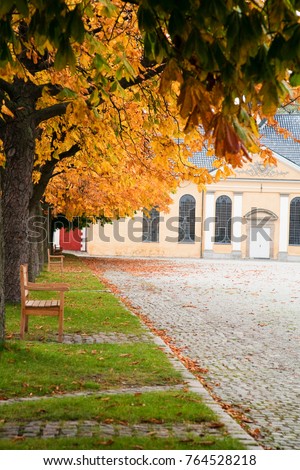 Copenhagen, Denmark - A large parade ground is lined with trees. In the background is a yellow building.