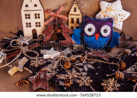 christmas composition with felt owl on wooden background