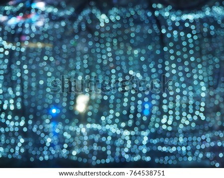 Festive elegant abstact background with bokeh christmas blue light. The decoration light bulb on Xmas tree and simple textures for your imagination. 
