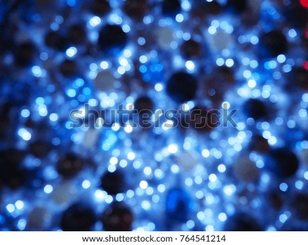 Festive elegant abstact background with bokeh christmas navy blue light. The decoration light bulb on Xmas tree and simple textures for your imagination. 
