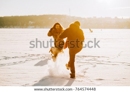 winter couple in love, walk on frozen lake