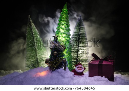 Christmas background with snowy fir trees. Snow Covered Christmas Tree stands out brightly against the dark blue tones of this snow covered scene