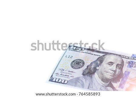 The corner of a one hundred dollar with Benjamin Franklin of the USA close-up on a white background. Money. Toned