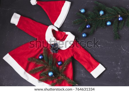 Christmas Baby clothes with Christmas toys on wooden background