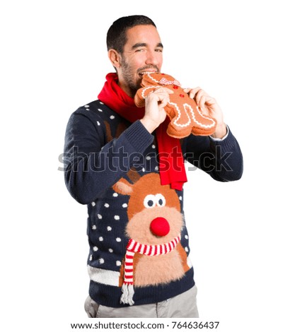 Happy young man on Christmas with a christmas cookie