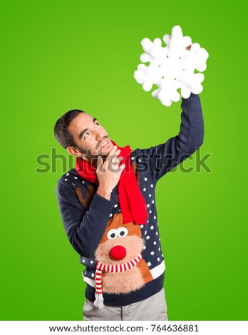 Young man on Christmas holding a snowflake