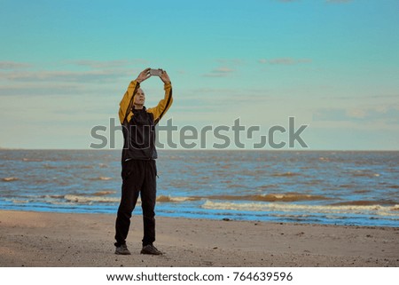 Man on the beach photographing