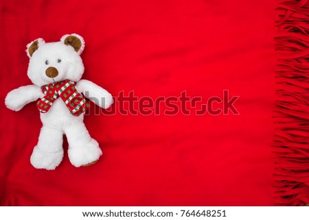 Plush white bear on a red veil