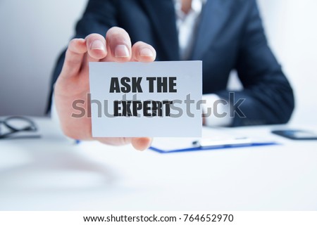 Businessman putting a card with text Ask the Expert Royalty-Free Stock Photo #764652970