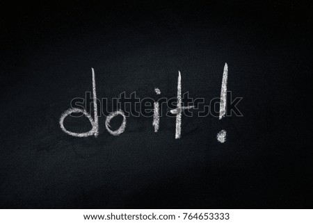 
The word "do it" is written on blackboard