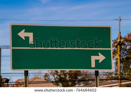 Blank directional road sign, green with white turn arrows