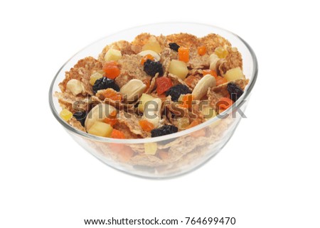 Homemade granola in a transparent plate. Cereals for milk or yoghurt with candied fruit. A picture to illustrate a healthy lifestyle or Breakfast, isolated on white background.