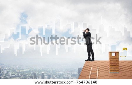Young businessman viewing cityscape in his binoculars Mixed media