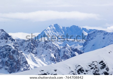 Mountains in the French Alps  with snow-covered rocks in winter day.  Avalanche zone.