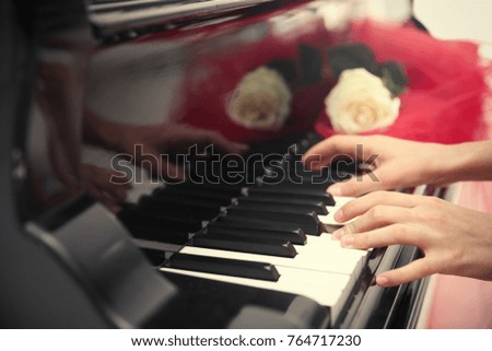 Talented woman playing piano, close up