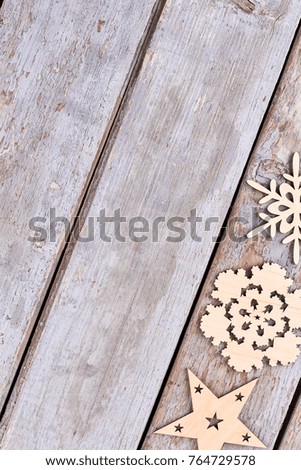Set of wooden Christmas decorations, top view. Cut out wooden snowflakes, star on old wooden background and copy space.