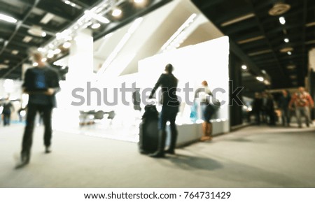 Trade fair visitors generic background. Intentionally blurred post production. Humans not recognizable.