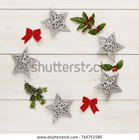 Christmas decoration handmade frame background, top view with copy space on white wooden table. Creative diy craft hobby, xmas wreath with silver stars, copy space