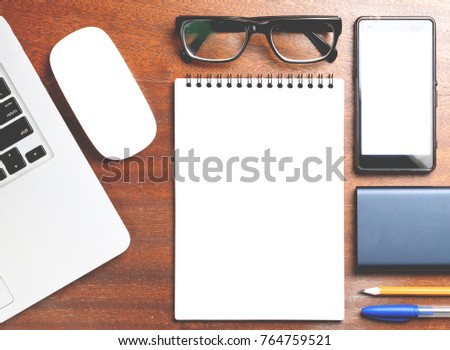 Business essentials. Top view of spiral blank notebook on wood desk background