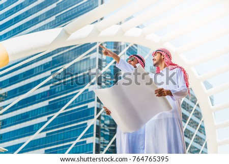 Arabian business man and engineer consultant on construction site for check out the new project with blueprint, Middle east new project and business trip