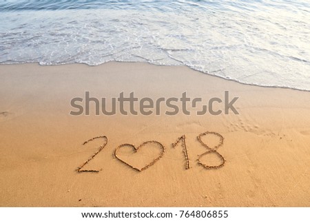 happy new year concept, 2018 written in the sand on a beach. Royalty-Free Stock Photo #764806855