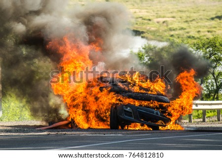 passenger car in a fire big fire, lots of smoke Royalty-Free Stock Photo #764812810