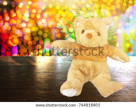 Gold Bear on Wooden table and beautiful background montage