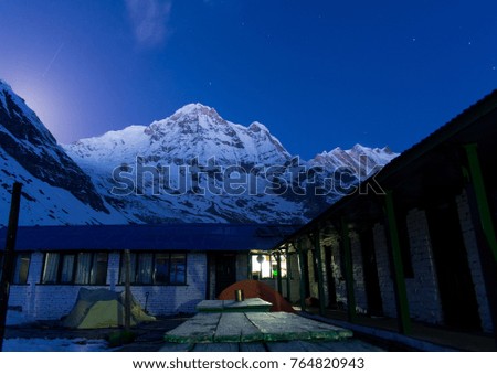 Scenic view of base camp with snow peak mountain at night. Beautiful nightscape of himalaya mountain range. It's landmark and popular for tourist attractions in Nepal. ABC. Annapurna Base Camp. Asia.
