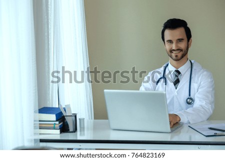 Smiling professional Caucasian Doctor with stethoscope in hospital. Handsome medicine health clinic practitioner. Medical healthcare.
