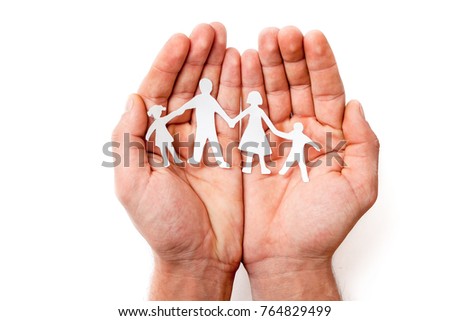 men's hands hold carved family silhouettes on a white background to protect the family, family security, family values