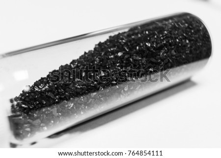activated carbon or granular in clear bottle is used in air purification, decaffeinate, gold purification, metal extraction, water purification, medicine, sewage treatment, air filters in gas masks Royalty-Free Stock Photo #764854111