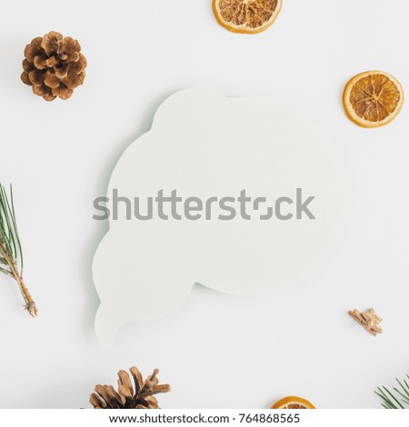 Icon thoughts with branch of a Christmas tree, cones, dry orange and Christmas balls on white background, top view. Flat lay