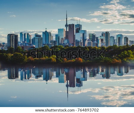 Toronto daytime cityscape and skyline mirrored in reflection below.  downtown buildings, businesses and condos in Toronto, Ontario, Canada