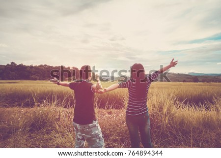 Asian,Romantic couple or Homosexuality, female love open arm freedom have fun on the rice field with sunset, Valentine's Day love concept