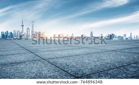 empty brick floor and cityscape of shanghai in blue sky
