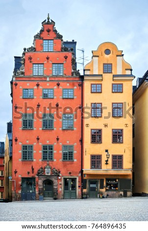 The couple of houses in the square, paved with cobblestones in the old town of Stockholm - Gamla Stan. Sweden.