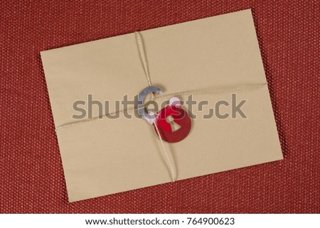 A secret envelope, a parcel bound with a rope, with a symbolic lock. Open the lock.