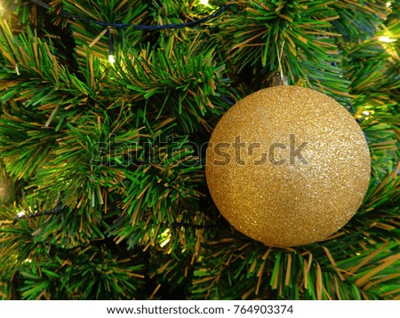 Gold Glitter Ball Ornament on the Christmas Tree 