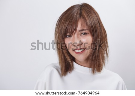Portrait of Asian girl smile. Young short hair Asian girl on white background.
