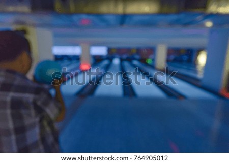 Abstract blurred image of people at bowling lane for sport background usage