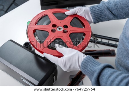the hands man holding reel 16mm film