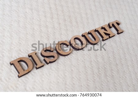 Word DISCOUNT abstract wooden letters, background textured winter light knitted woolen