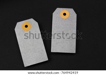 blank gray paper label on black background. mockup paper for text message or artwork. three paper card.