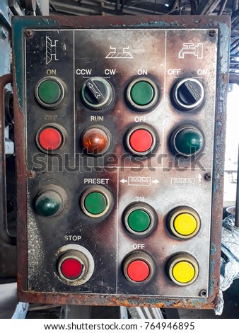 The machine control cabinet with push button start-stop button red yellow green. Very old cabinets.