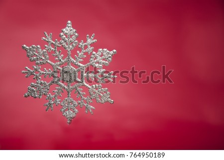 snowflake on red backgroundSnowflake on wood