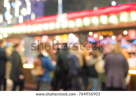 Blurred image bokeh of People walking, shopping at Christmas Market in Leicester Square, London.