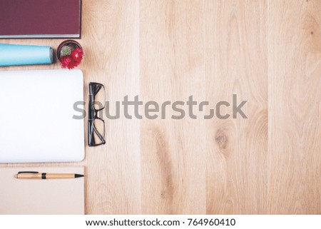 Top view of wooden office desk with various items and copy space. Mock up