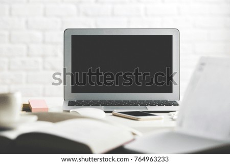 Hipster workplace with empty laptop screen, smartphone, supplies and other items. Close up. Creative designer office, education, occupation, freelance and lifestyle concept. Mock up 